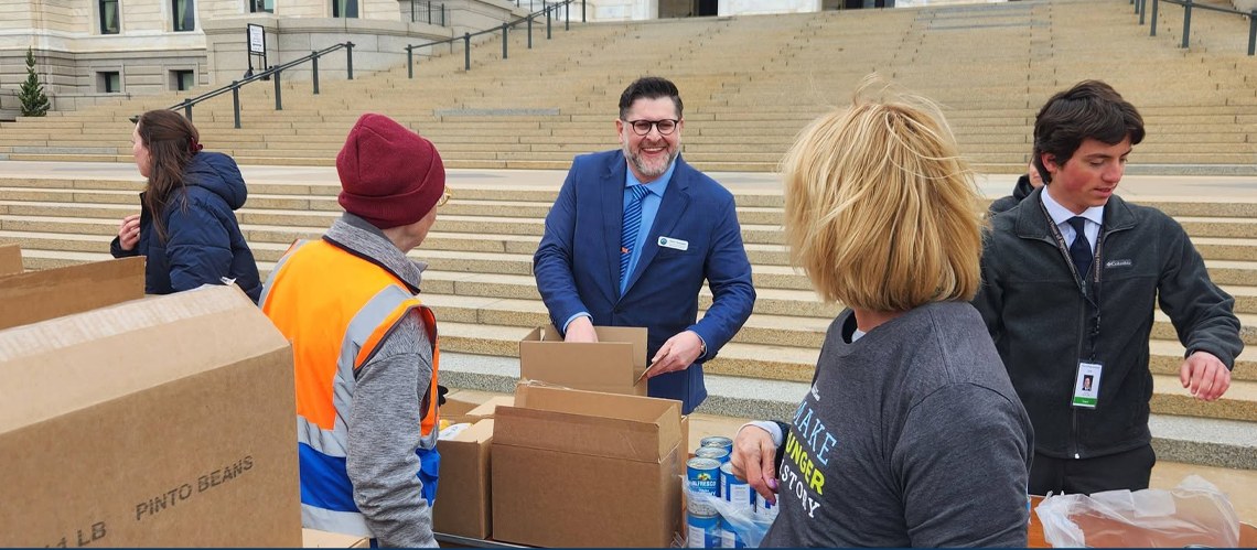Aaron Schweiger volunteering at a community food distribution